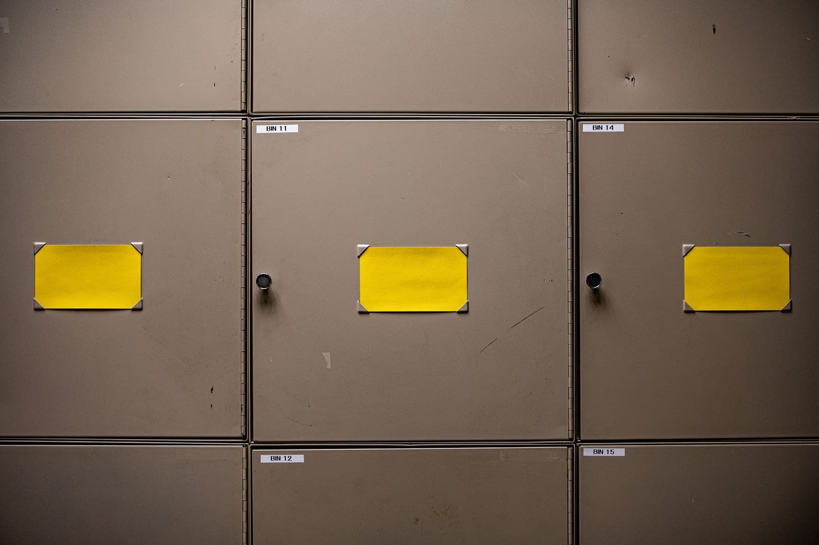 Steel cabinets with yellow labels lined up along a wall