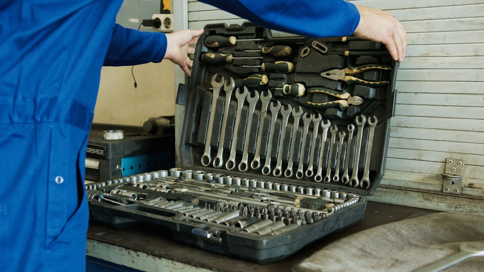 A mechanic laying out a full tool set for vehicle work