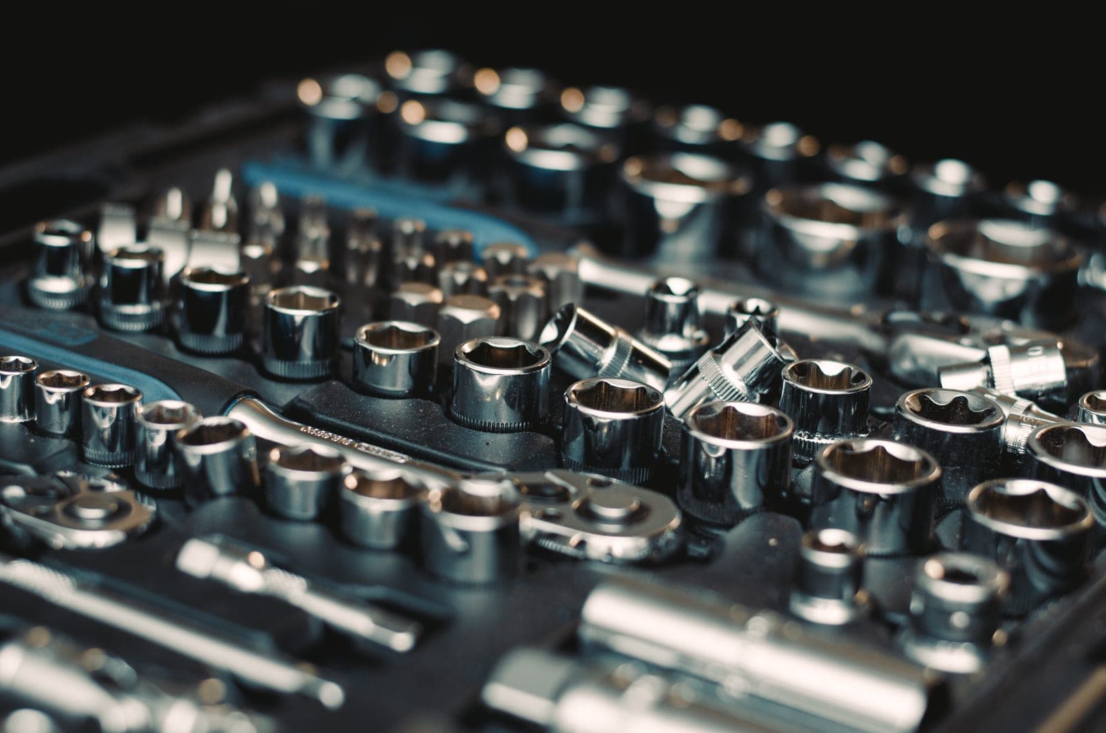 A socket wrench set laid out by size, photographed close up