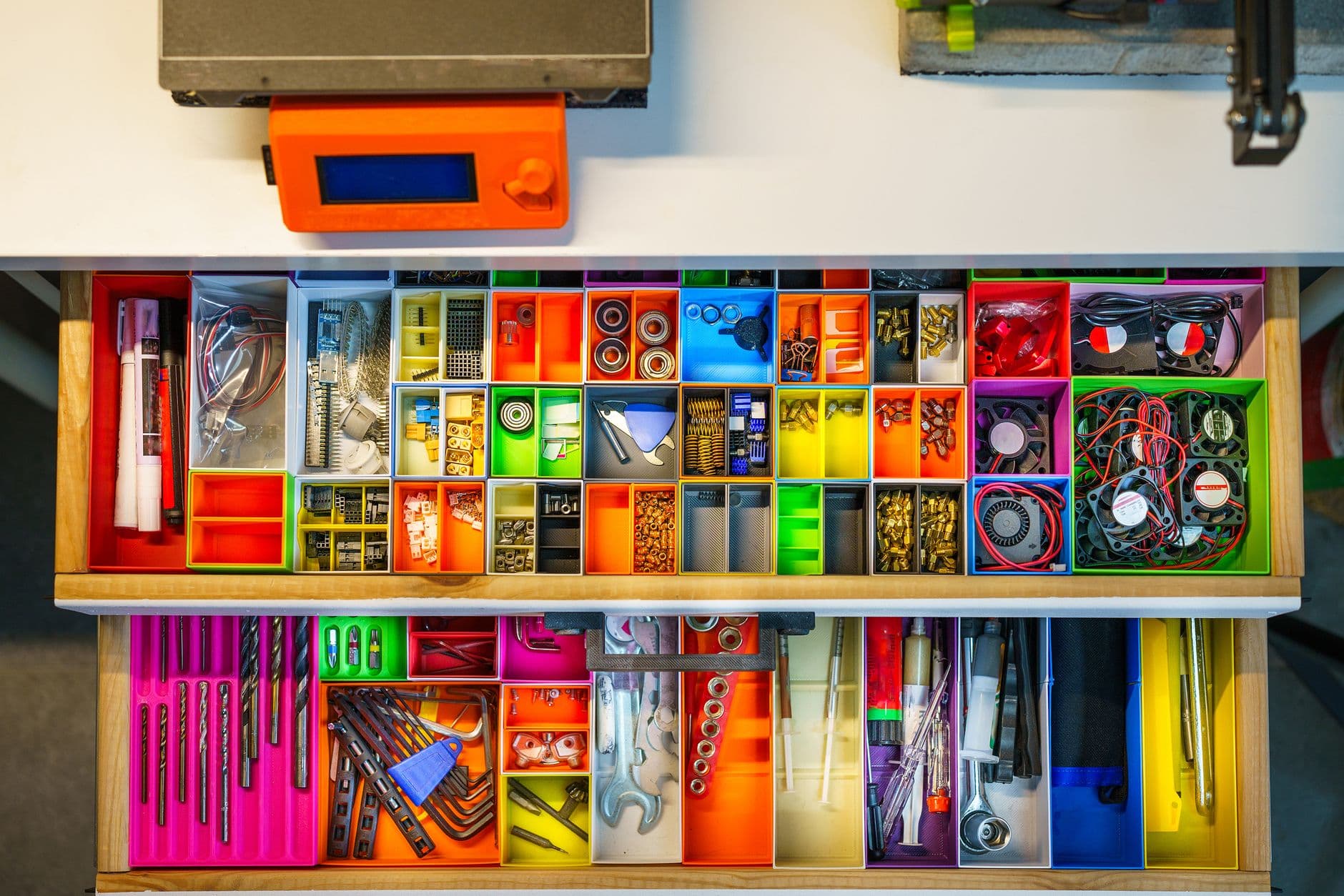 A workshop drawer holding neatly organized tools and components