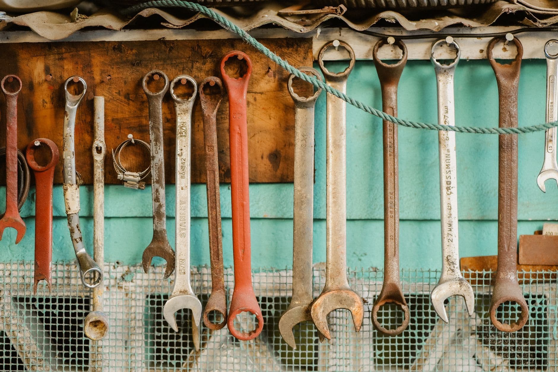 A row of wrenches hanging on a workshop wall