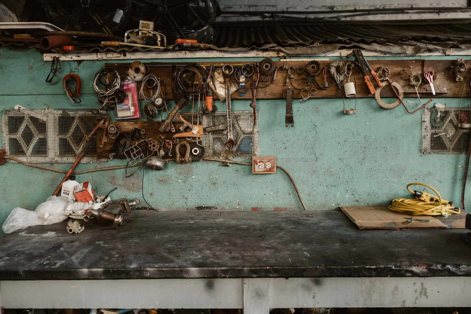 Tools and accessories on a wall rack in a small rustic workshop