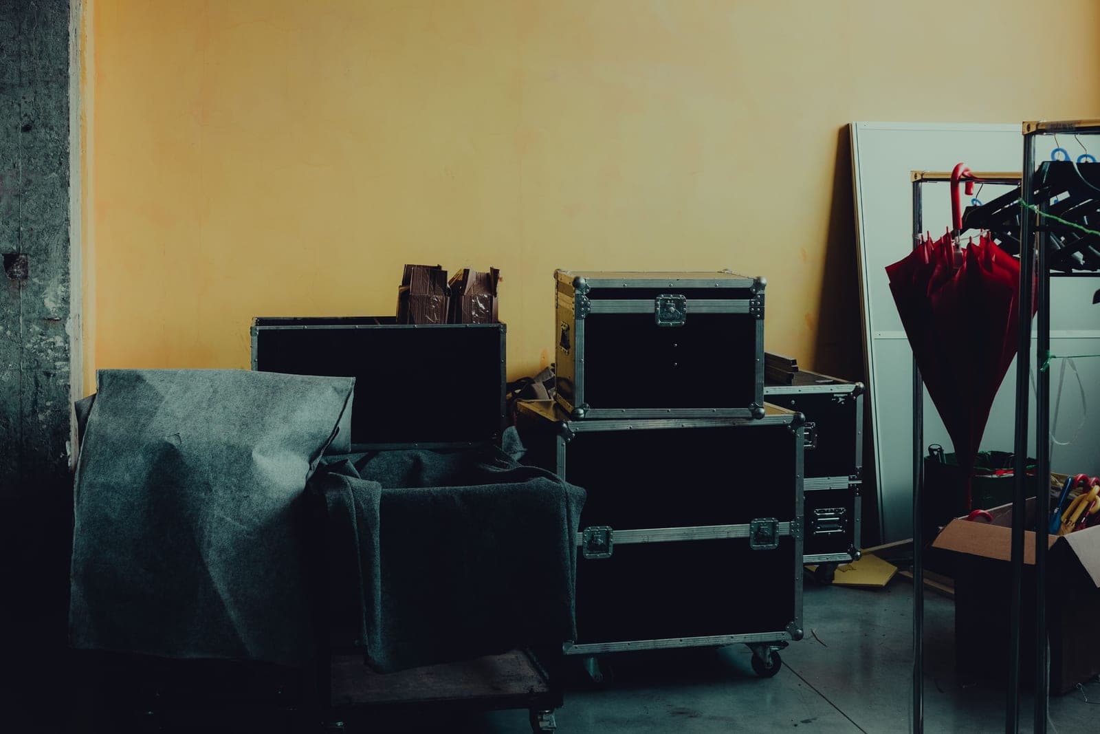 Boxes and hard cases stacked against a workshop wall
