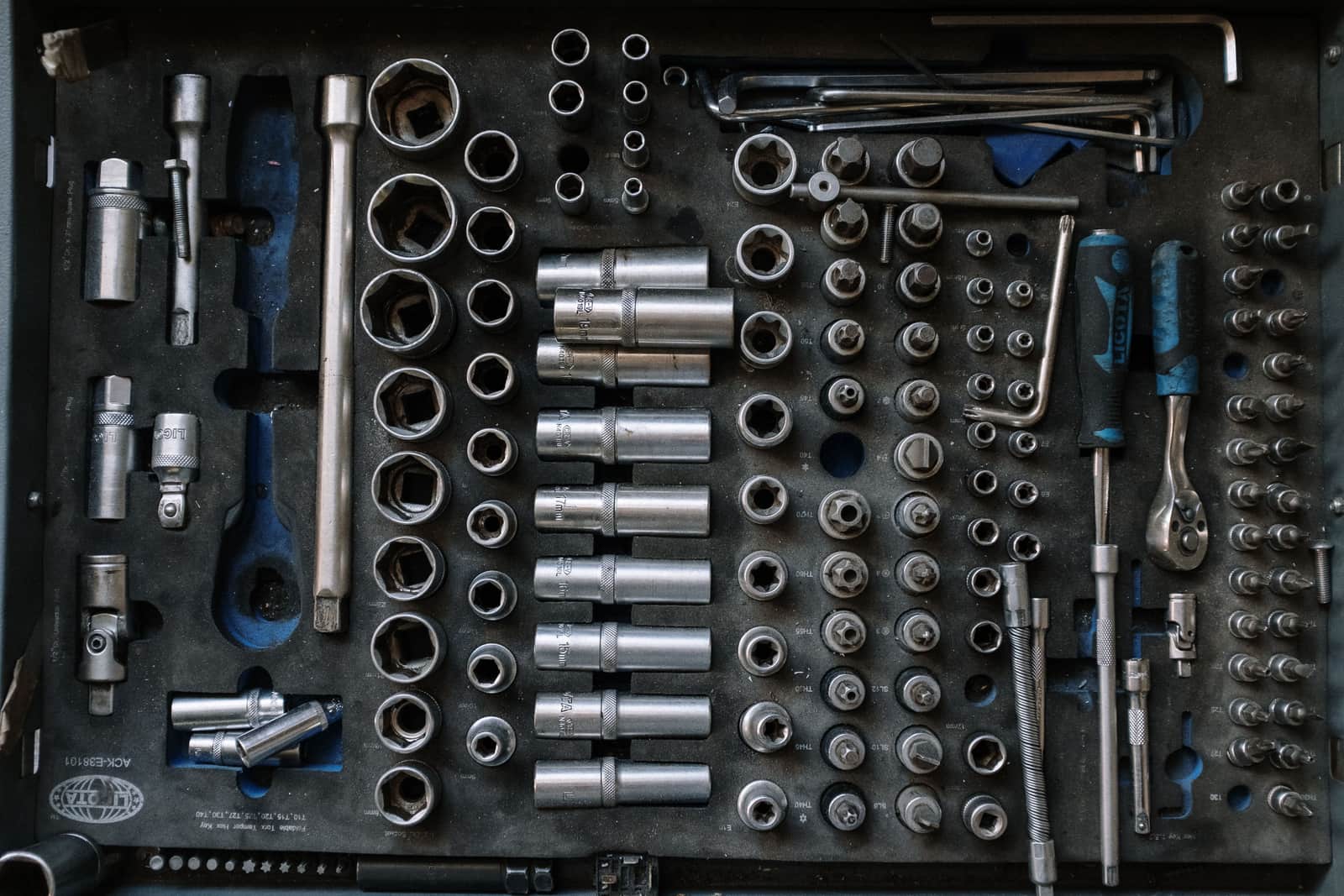 A complete tool set laid out flat and sorted by type on a workshop surface